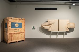 Shipping crate and  Sculpture: Walter Redinger, Adhesion Wall #1, 1968, fiberglass, 122 x 305 cm;  Gift of Avrom Isaacs, 1983<br>Installation image from Restored Treasures Part 1