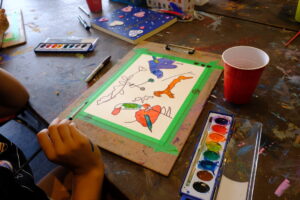 A person painting unique shapes in the art studio. 